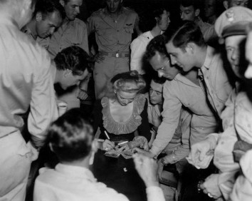 Carole-Landis-visits-with-G.I.s-and-signs-autographs-in-the-Pacific-during-WWII.-Landis-traveled-more-than-100000-miles-during-the-war-and-spent-more-time-visiting-troops-than-any-other-